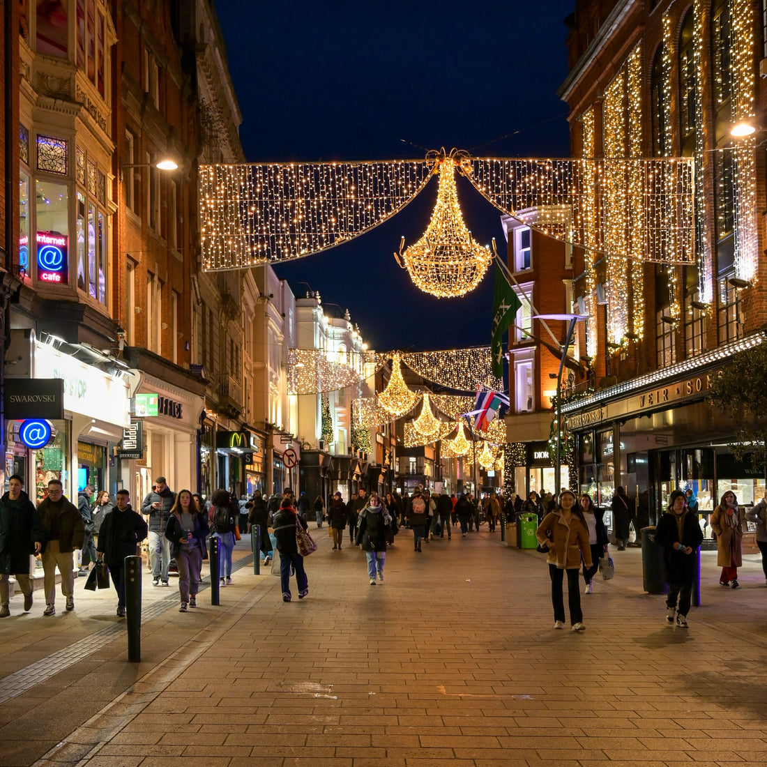 Grafton Street in Dublin decorated with Christmas lights and evening shoppers