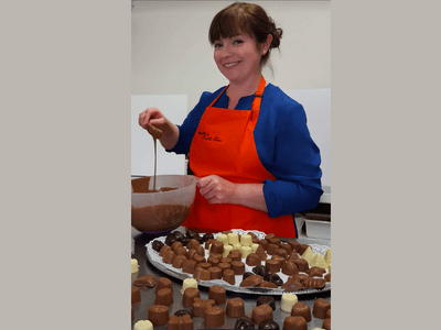 Marlene Foy of Marlene's Chocolate Haven showcasing her handmade Irish chocolates in her Westport studio