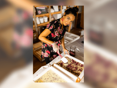 Raquel from The Moher Soap Co. in her West Clare workshop, surrounded by handmade soaps and natural botanical ingredients.