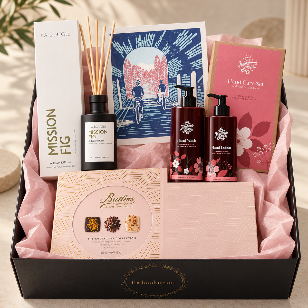 A Beautiful Home Hamper with La Bougie Mission Fig diffuser, Sorrell O'Reilly art, The Handmade Soap Company hand care and Butlers pink chocolates